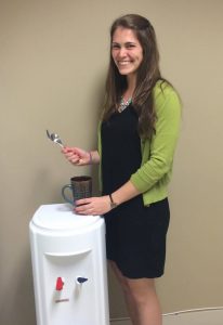 Brooke Cotta, Marlborough's Green Ambassador, stands by the water cooler with her reusable dinnerware