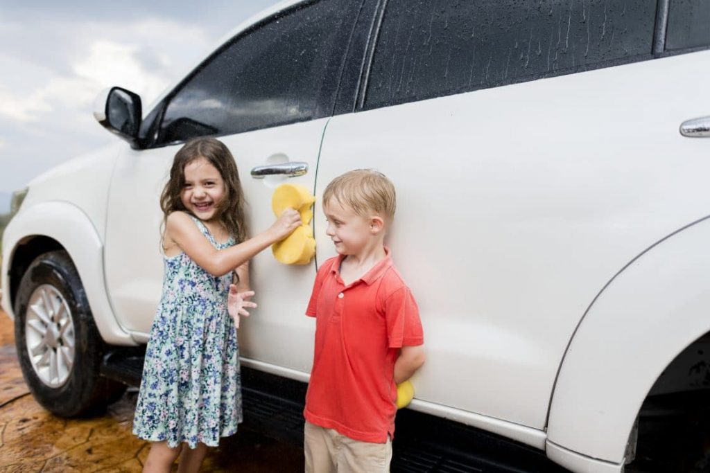 kids washing car at home
