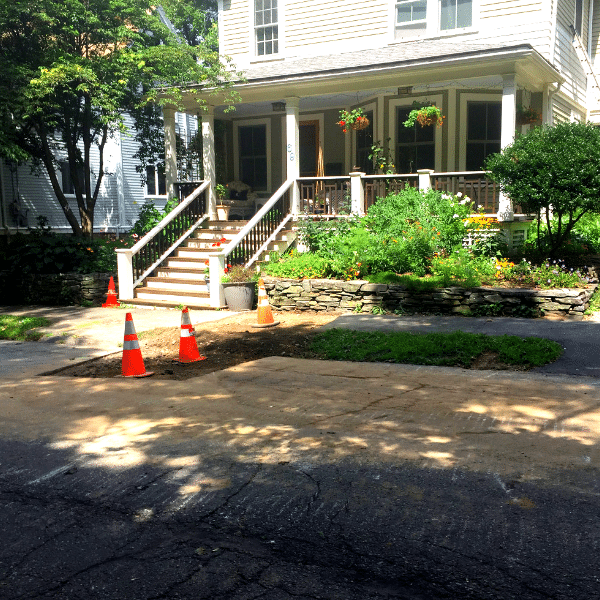Lead service replacement program in Newton, MA. Newton home with construction cones.